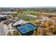 A bird's eye view showcasing sports amenities like tennis courts, skate park and an adjacent soccer field in a suburban setting at 4311 Del Rio Ct, Denver, CO 80239