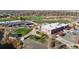 An aerial view of a complex with sports facilities and landscaping in a suburban neighborhood near a lake at 4311 Del Rio Ct, Denver, CO 80239