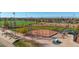 Aerial view of a well-maintained baseball field with covered benches, and walking path at 4311 Del Rio Ct, Denver, CO 80239