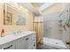 Modern bathroom featuring walk-in shower with tile surround and vanity with white cabinet at 4311 Del Rio Ct, Denver, CO 80239