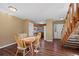 Cozy dining area featuring hardwood floors, stairs, and seamless transition to the kitchen for easy entertaining at 4311 Del Rio Ct, Denver, CO 80239