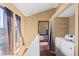 Hallway featuring windows, laundry area, and seamless transition to the bedrooms at 4311 Del Rio Ct, Denver, CO 80239