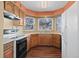 Functional kitchen with stainless appliances and a window overlooking the yard, filling the space with natural light at 4311 Del Rio Ct, Denver, CO 80239