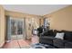 Bright living room featuring a sliding glass door, hardwood floors, and plush seating for relaxing and entertaining at 4311 Del Rio Ct, Denver, CO 80239