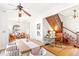 Dining room with a ceiling fan and a staircase with wood detailing in the background at 3217 Irving St, Denver, CO 80211