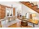 Open concept dining room with a decorative staircase and exposed brick wall at 3217 Irving St, Denver, CO 80211