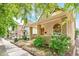 Charming exterior showcasing a stone-columned porch and lush landscaping along the sidewalk at 3217 Irving St, Denver, CO 80211