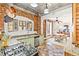 Bright kitchen features brick accent wall, stainless appliances, and attached breakfast nook at 3217 Irving St, Denver, CO 80211