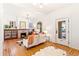 Bright living room with hardwood floors, fireplace, and a charming arched window to the front porch at 3217 Irving St, Denver, CO 80211