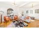 Bright living room featuring hardwood floors, neutral tones, and large windows at 3217 Irving St, Denver, CO 80211