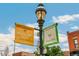 Street view featuring Highland Square banners, a vintage lamp post, and classic brick buildings at 3217 Irving St, Denver, CO 80211