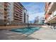 Outdoor pool covered for the off-season, surrounded by apartment buildings on a sunny day, offering potential community amenities at 1121 Albion St # 804, Denver, CO 80220