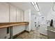 Laundry room featuring stacked washer/dryers, ample counter space, and practical flooring for convenient chores at 1121 Albion St # 804, Denver, CO 80220