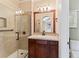 Bathroom with glass shower, dark wood vanity, light counters and a decorative framed mirror at 1344 Royal Troon Dr, Castle Rock, CO 80104