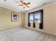 Cozy bedroom with window, ceiling fan, and neutral paint tones, perfect for relaxation at 1344 Royal Troon Dr, Castle Rock, CO 80104