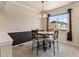 Bright dining area features a round table, four chairs and a large window with neighborhood views at 1344 Royal Troon Dr, Castle Rock, CO 80104