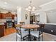 Cozy dining area with a round table, four chairs, and views of the kitchen and living area at 1344 Royal Troon Dr, Castle Rock, CO 80104