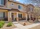 Inviting townhome featuring a covered front porch and meticulously maintained landscaping at 1344 Royal Troon Dr, Castle Rock, CO 80104