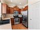 Featuring stainless steel appliances, wood cabinets and hardwood floors, this kitchen is a chef's dream at 1344 Royal Troon Dr, Castle Rock, CO 80104