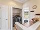 Convenient laundry room with washer, dryer, storage cabinets, and access to an adjacent office area at 1344 Royal Troon Dr, Castle Rock, CO 80104