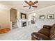 Cozy living room featuring a fireplace, plush carpeting, and seamless access to the dining area at 1344 Royal Troon Dr, Castle Rock, CO 80104