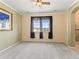 Spacious main bedroom with large window, ceiling fan and ensuite bathroom access at 1344 Royal Troon Dr, Castle Rock, CO 80104