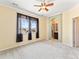 Bright main bedroom with ensuite bathroom access, ceiling fan and neighborhood views at 1344 Royal Troon Dr, Castle Rock, CO 80104