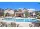 Community swimming pool with lounge chairs, seating area and surrounding apartment buildings at 1344 Royal Troon Dr, Castle Rock, CO 80104
