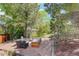 Outdoor seating area surrounded by lush greenery and a well-maintained yard at 9141 Roundtree Dr, Highlands Ranch, CO 80126