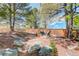 A charming backyard retreat featuring comfortable outdoor seating, a fire pit, and mature trees at 9141 Roundtree Dr, Highlands Ranch, CO 80126