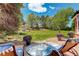 Patio seating and backyard view with manicured lawn and lush greenery at 9141 Roundtree Dr, Highlands Ranch, CO 80126