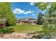 Expansive backyard with lush lawn and mature landscaping, offers a picturesque retreat, and ample space at 9141 Roundtree Dr, Highlands Ranch, CO 80126