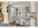 Charming bar area features granite countertops, built-in shelving, and seating for two at 9141 Roundtree Dr, Highlands Ranch, CO 80126