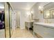 Modern bathroom with double vanity, stylish mirrors, and a spacious closet at 9141 Roundtree Dr, Highlands Ranch, CO 80126