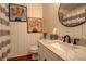 Charming bathroom featuring a granite vanity, modern sink, and stylish decor at 9141 Roundtree Dr, Highlands Ranch, CO 80126