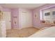Cozy bedroom with lilac walls, a window seat, and ample closet space at 9141 Roundtree Dr, Highlands Ranch, CO 80126
