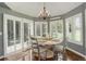 Cozy dining area featuring white plantation shutters, a chandelier, and a round table at 9141 Roundtree Dr, Highlands Ranch, CO 80126