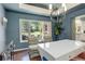 Elegant dining room featuring a modern chandelier, large windows, and beautiful backyard views at 9141 Roundtree Dr, Highlands Ranch, CO 80126