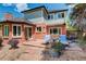 A lovely outdoor patio boasts comfortable seating, beautiful purple flowers, and meticulous stone details at 9141 Roundtree Dr, Highlands Ranch, CO 80126