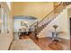 Elegant foyer with hardwood floors, a staircase with iron railing, and a view into the formal dining room at 9141 Roundtree Dr, Highlands Ranch, CO 80126