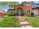 Charming brick home featuring a well-manicured lawn and a welcoming brick walkway to the front entrance at 9141 Roundtree Dr, Highlands Ranch, CO 80126
