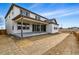 Home's backyard with a covered patio, and a spacious yard for outdoor activities at 9329 Russell Cir, Arvada, CO 80007