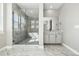 Primary bathroom featuring a large shower, marble floors, and a double vanity at 9329 Russell Cir, Arvada, CO 80007