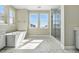 Bright bathroom featuring a soaking tub, a separate glass shower and dual windows at 9329 Russell Cir, Arvada, CO 80007