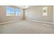 A spacious bedroom with carpet flooring, neutral walls and many large windows at 9329 Russell Cir, Arvada, CO 80007