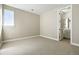 Cozy bedroom with neutral walls, soft carpet, and an ensuite bathroom at 9329 Russell Cir, Arvada, CO 80007