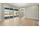 Bright open dining room with mountain views, sliding glass doors to the patio and modern lighting at 9329 Russell Cir, Arvada, CO 80007