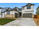 Contemporary two-story home featuring a three-car garage, stone accents, and well-maintained landscaping at 9329 Russell Cir, Arvada, CO 80007