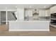 Modern kitchen with quartz countertops, stainless steel appliances, and a large island at 9329 Russell Cir, Arvada, CO 80007