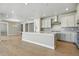 Spacious kitchen featuring a large island, stainless steel appliances, and modern lighting at 9329 Russell Cir, Arvada, CO 80007